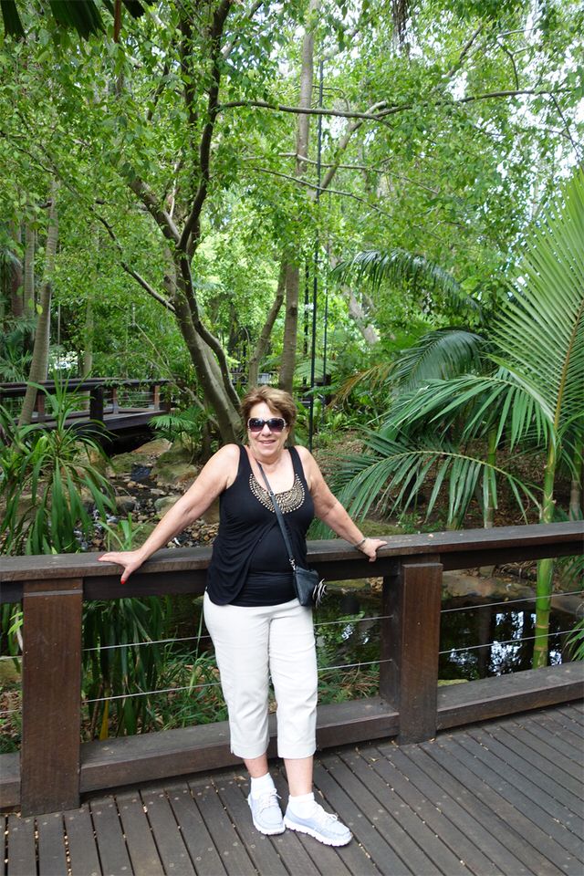 Our friend, Denise, standing in front of the lush rainforest parkland.